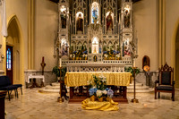 Ornate Church Altar Interior with Statues and Flowers