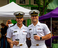 Military men in white uniforms with coffee cups.