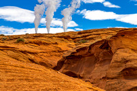 Smoke Plumes Over Desert Landscape