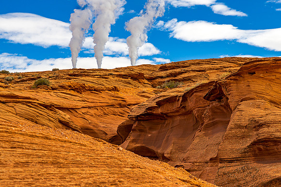 Smoke Plumes Over Desert Landscape
