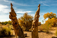 Wooden Wolf Carvings in Garden with Autumn Foliage