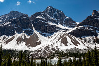 Snowy Mountains, Evergreen Forest, and Partially Frozen Lake