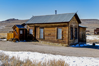 Historic Wooden Building in Desolate Snowy Landscape