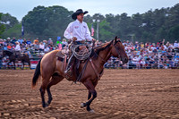 Cowboy Rides Horse in Rodeo Arena