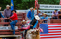 Cowboy Rides Bull at Rodeo