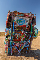 Colorful spray-painted vehicle in an art installation.