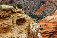 Desert Landscape with Layered Sandstone Formations and Green Veg