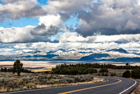 Winding Road Towards Snow-Capped Mountains