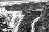 Powerful Waterfall Over Layered Rock Formations