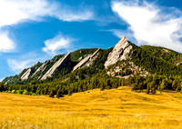 The Flatirons and golden meadow in Boulder, Colorado.