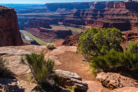 Panoramic View of a River Winding Through Red Rock Canyon