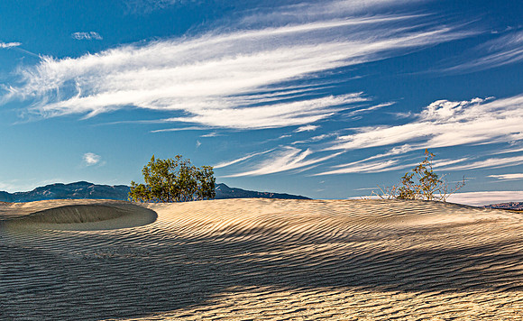 Desert Sand Dunes Under Streaked Sky