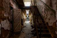 Abandoned Building Corridor with Peeling Paint and Stairs