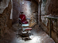 Red Barber Chair in Abandoned Prison Cell