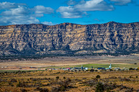Desert Settlement Under Mountain Range