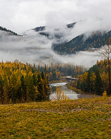 Autumn River Valley with Foggy Mountains