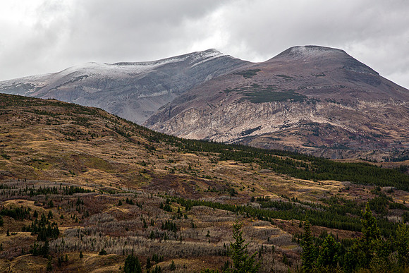 Mountain Range with Snow-Capped Peaks and Forest
