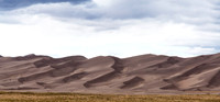 Dramatic Sand Dunes Under Cloudy Sky
