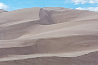 Vast Sand Dunes Under Blue Sky