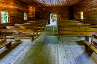Old Wooden Church Interior with Sunlight and Pews
