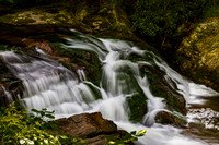 Moss-Covered Waterfall in Forest