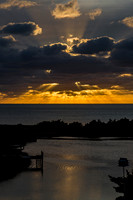 Dramatic Sunset Over Water with Golden Rays