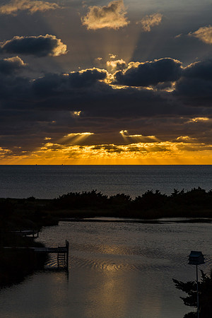 Dramatic Sunset Over Water with Golden Rays