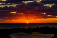 Dramatic Sunset Over Ocean and Landscape