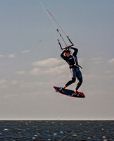 Kiteboarder performs aerial jump over ocean