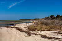 Coastal landscape with beach, ocean and blue sky.