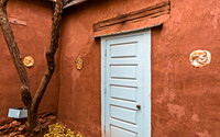 Adobe Wall with Blue Door and Tree