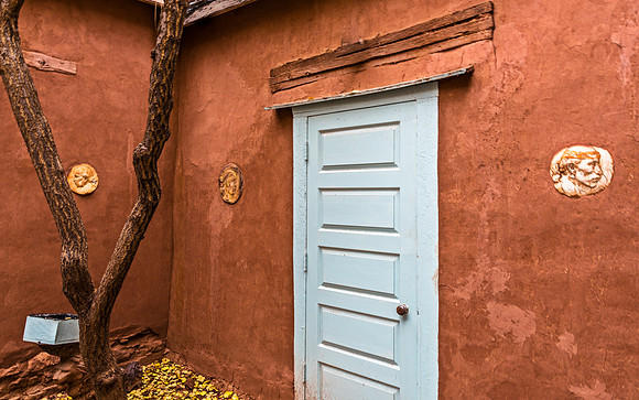 Adobe Wall with Blue Door and Tree