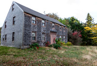 Old Weathered Wooden House in a Grassy Field