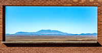 Desert Mountain View Framed by Brick Window