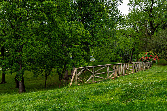 Rustic Wooden Fence on Green Hillside