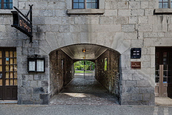 Stone Archway leading to a Gated Green Space