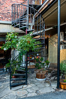 Outdoor Courtyard with Spiral Staircase and Greenery