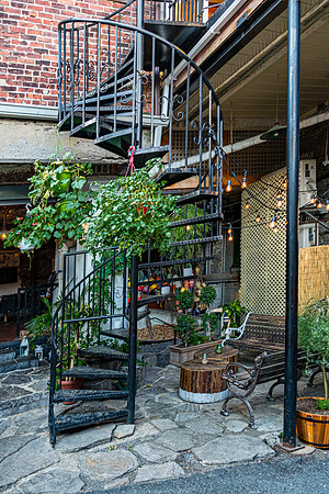 Outdoor Courtyard with Spiral Staircase and Greenery