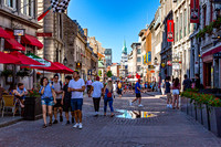 People Walk Down Historic Street in Old Montreal