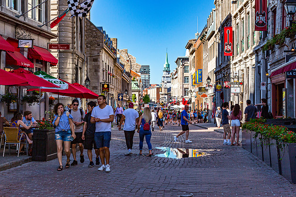 People Walk Down Historic Street in Old Montreal