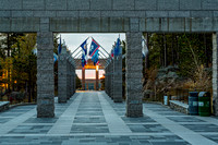 Pathway with Pillars and Flags at Sunrise