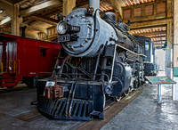 Vintage Steam Locomotive and Caboose Displayed Indoors