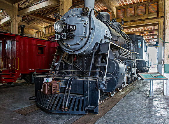 Vintage Steam Locomotive and Caboose Displayed Indoors