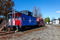 Red and Blue Private Railcar with Number 487 on Tracks