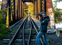 Photographer on Rustic Railroad Bridge