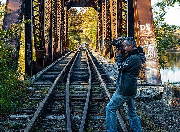 Photographer on Rustic Railroad Bridge
