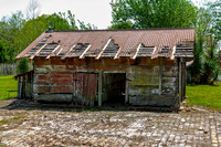 Dilapidated Wooden Shed with Rusted Metal Roof