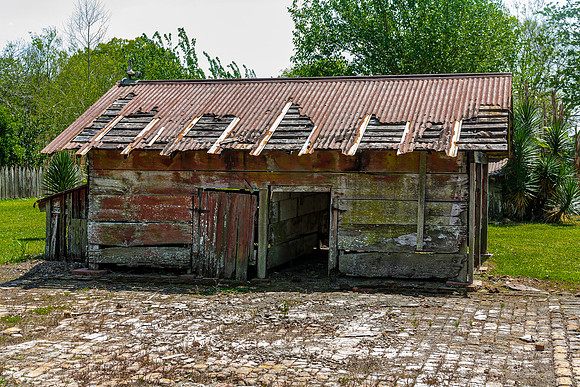 Dilapidated Wooden Shed with Rusted Metal Roof