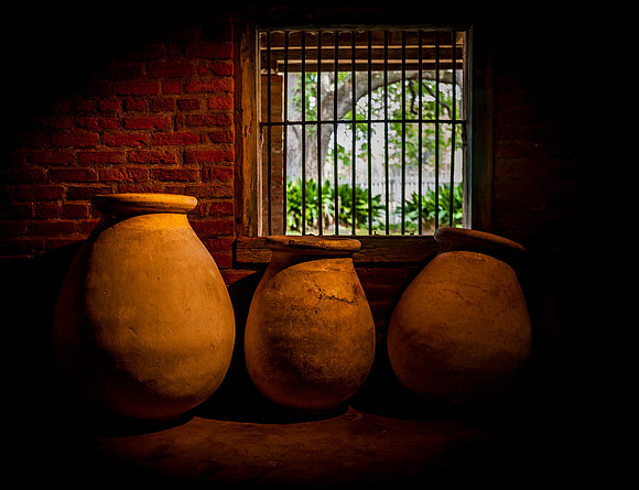 Traditional Clay Pots in a Dark Room
