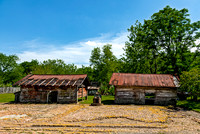 Historic Slave Cabins Under Blue Sky